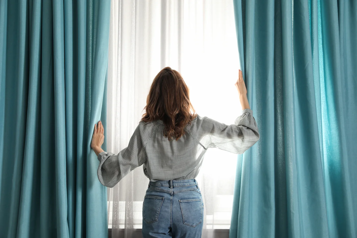 woman-opening-window-curtains-at-home-in-morning-2026-01-24-19-31-02-utc